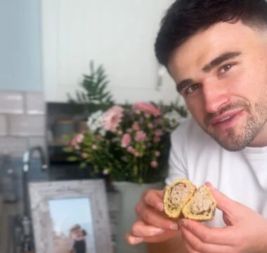 Matty holds one of his freshly baked sausage rolls